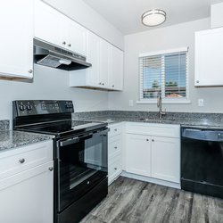 Kitchen with lots of cabinets and black all-electric appliances at Carlson Apartments, located in Colorado Springs, CO