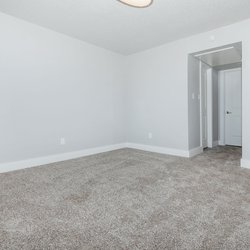 Carpeted bedroom with ample outlets at Carlson Apartments, located in Colorado Springs, CO